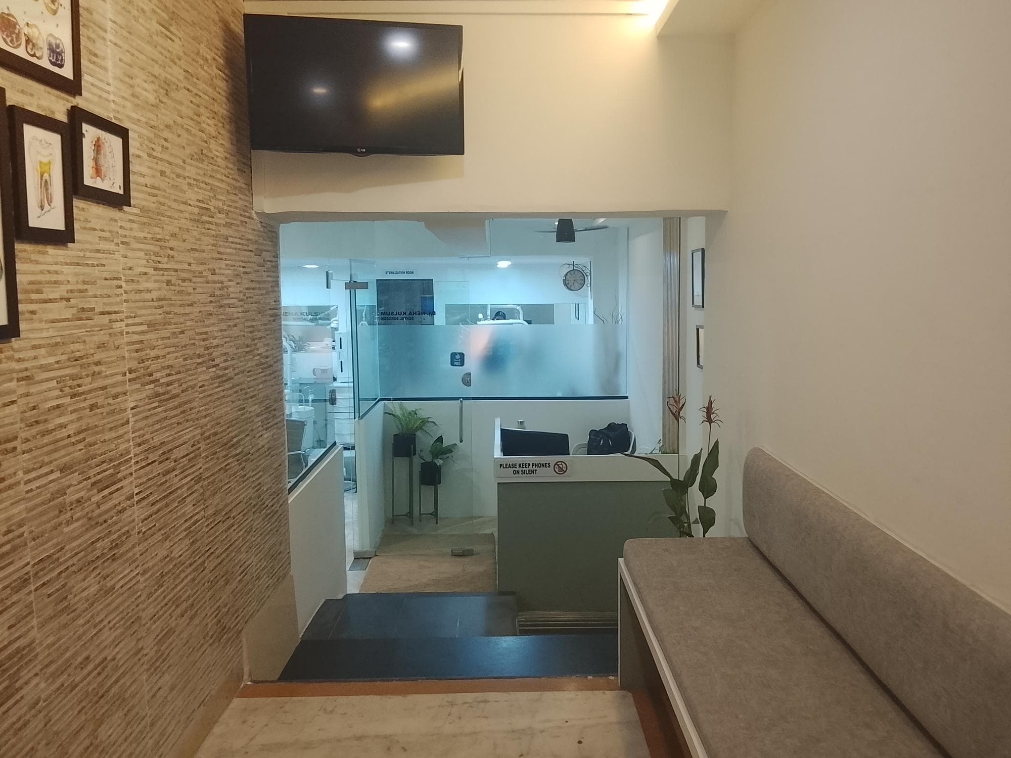 The entrance and waiting lounge at DentalNisaa Oral Care, looking through to the reception desk